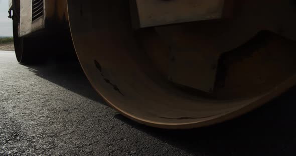 Steamers Smooth Hot Asphalt. Builds A New Road alt