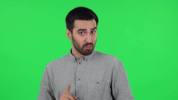 Portrait of Brunette Guy Is Talking About Something Then Making a Hush Gesture, Secret. Green Screen alt