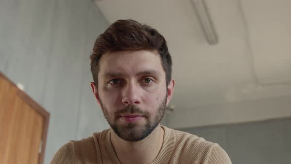 Young male looking at camera talk make live video conference call online at home alt