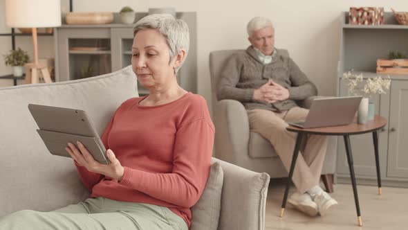 Senior Couple Using Devices at Home alt