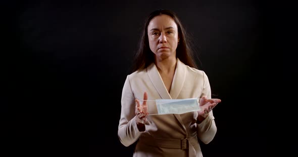 Portrait of a Woman with Long Hair and a Formal Dress on a Black Background. She Smiles, Shows Off a alt