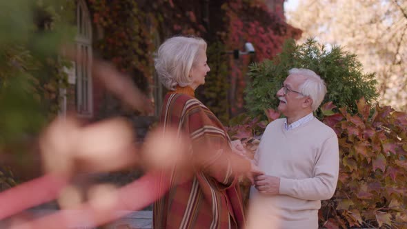 Handsome senior couple embracing in autumn park