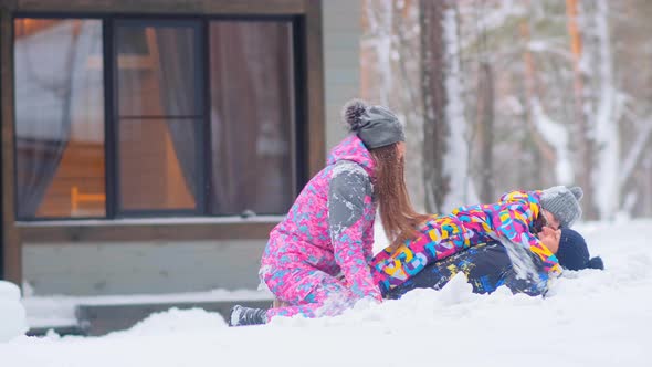 Joyful Family with Little Daughter Has Fun in Snowdrift alt