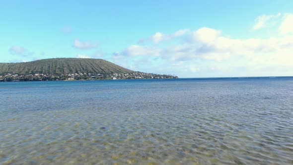 gliding above the ocean towards portlock beach neighborhood on oahu hawaii alt