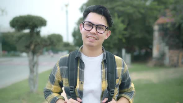 Traveler Asian man feeling happy smiling to camera holiday trip at Ayutthaya, Thailand, backpacker alt