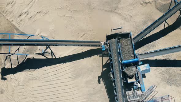 Grinding Process of Excavated Gravel in a Top View. Mining Excavation Equipment alt