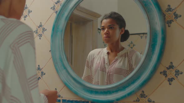 Close Up of Exited 20s African American Woman Waiting for Pregnancy Test Result Standing in Bathroom alt