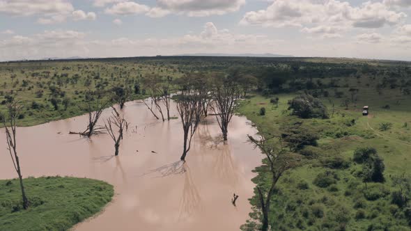 Waterhole lake in Laikipia, Kenya. High aerial drone view of Kenyan landscape alt