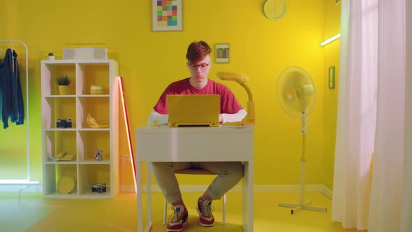 Man Is Working On Yellow Laptop