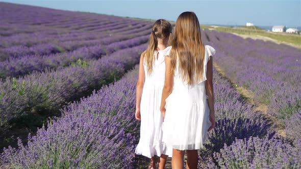 Girls in Lavender Flowers Field at Sunset in White Dress alt