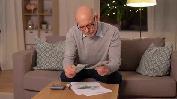 Senior Man Counting Money at Home alt