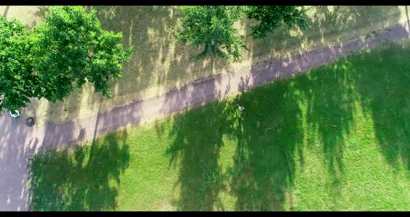 Young teenage boy running on the grass alt