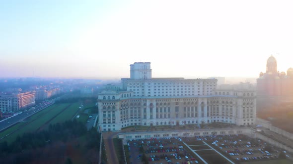 Sunset Drone Shot Of The Palace Of The Parliament in Bucharest, Romania  alt