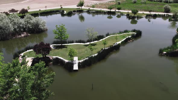 Idaho Pond Surrounded by Green Grass and Trees Aerial View Drone 4K alt