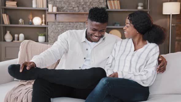 Family Couple Married Spouses African Man and Biracial Woman Talking Laughing Sitting on Sofa alt