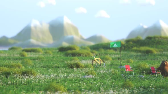 Friendly bear character sitting in the campsite. Meadow camp with mountain view. alt