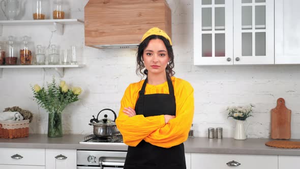 Portrait Serious Housewife Crossing Hands Looking Camera in Home Modern Kitchen alt