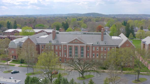 Aerial of large brick Federalist style building on college university campus. Franklin Marshall Coll alt