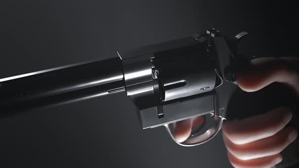 A hand holding a pistol that shots not bullets but a red flag with BANG! word alt