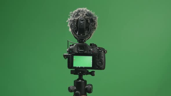 Close Up Hand Male Recording Video With Digital Camera In Green Screen Studio alt