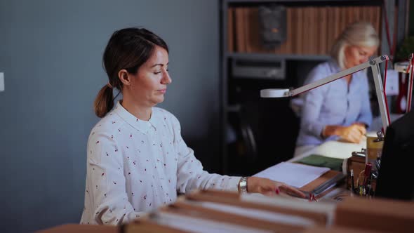Businesswoman checking smartphone in the office alt