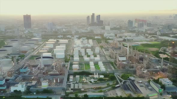 4k aerial view drone of refinery oil petroleum production factory with river reflecting surface sunr alt