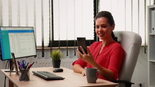 Talking with Colleague Using Phone Webcam alt