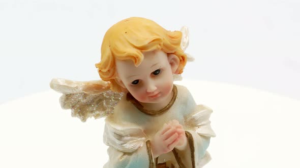 Beautiful Little Angel Statuette on a White Background 