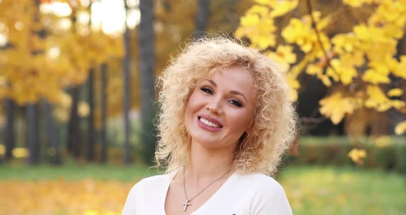 Happy Hipster Girl with Volumed Hair and Makeup Looking at Camera and Smiling alt
