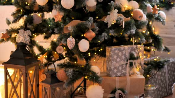 Christmas Decorations on Christmas Tree and Gifts on Floor alt