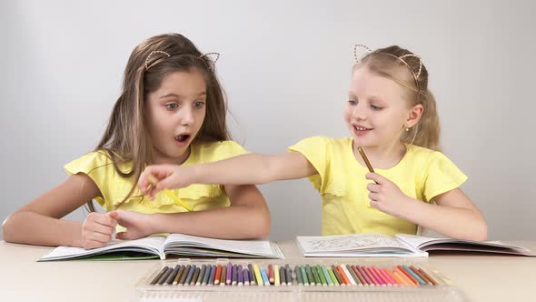 Funny and Funny Children. Children at the Table Dance and Create. Two Children Are Sitting at a alt