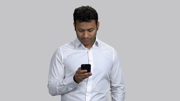 Despicable Young Man Taking Photo on His Smartphone alt