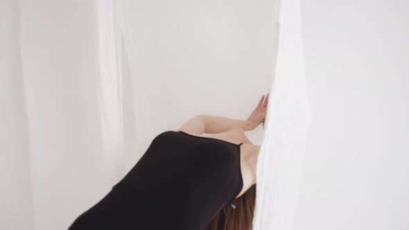 A Striking Young Girl in an Original Top with Fluttering Hair Poses and Waves with Light Pieces of alt