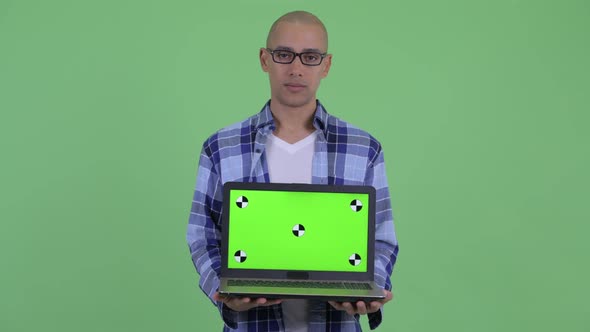 Stressed Bald Hipster Man Showing Laptop alt
