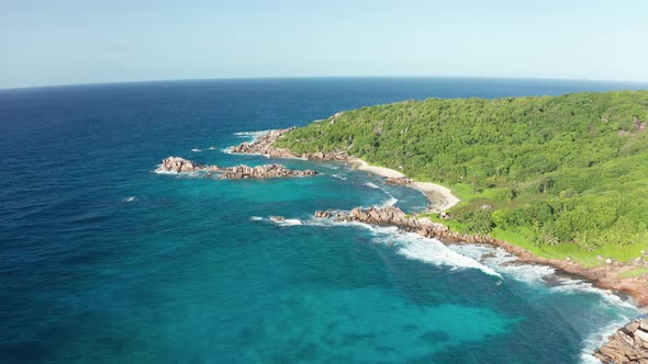 Aerial dolly over southern shoreline La Digue island, Seychelles