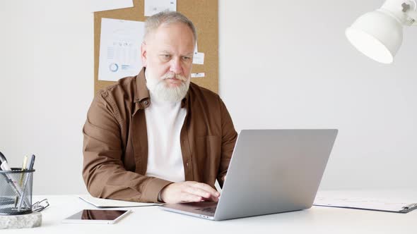 man fills out paperwork on his work desk