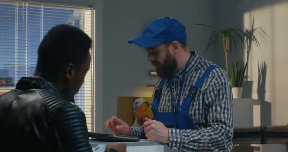 Man Collecting a Package in a Delivery Center alt