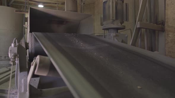 Side Angle View of Loading Bulk Belt Conveyor on Factory Producing Cement. Equipment on Concrete alt