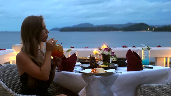 Woman in Sexy Evening Dress Sip Cocktail Via Straw in Luxury Hotel Restaurant alt