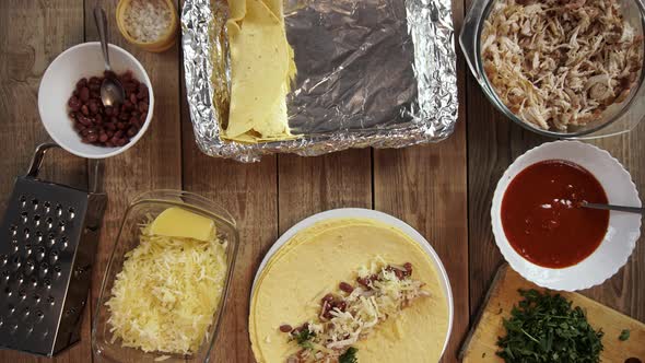 Stop Motion of Cooking Traditional Mexican Enchilada on Wooden Table Filmed From Above alt