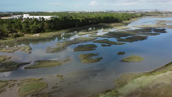 Flying Over Swampland Towards Small Islets On A Sunny Day In Seixal, Portugal. Aerial alt