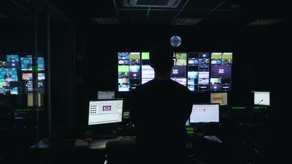 Man Manages the Broadcast in TV Control Room