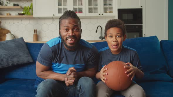 Excited Black Family Basketball Fans Watching Game on Tv and Celebrating Victory alt
