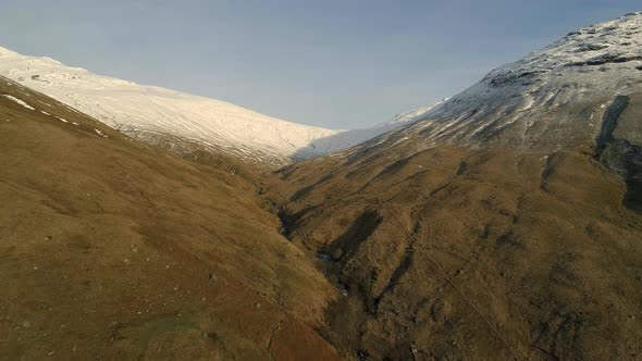 Aerial View of a Valley in Scotland with Forests alt