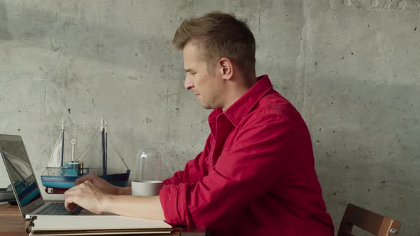 Cheerful American Hipster Working Remotely From Home on Netbook Laptop Smiling Male Freelancer