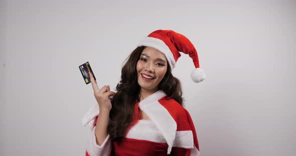 Young beautiful woman in Santa Claus costume show credit card alt