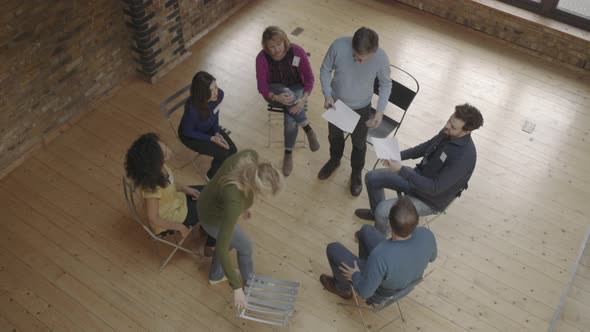 Group therapy session workshop, group sitting in circle