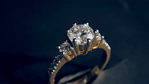 Extreme detailed of diamond ring close up shot while rotating on dark background alt