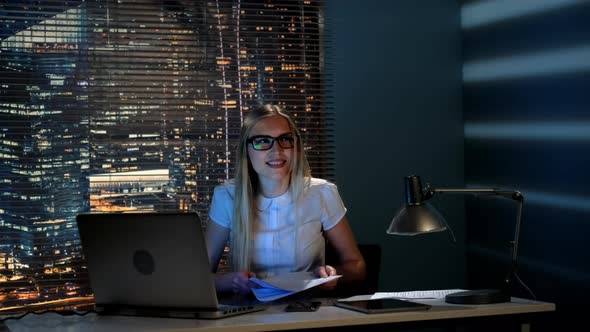 Slow Motion of Smiling Female Student Throwing Papers Up alt