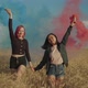 Diverse Women Walking with Smoke Bombs Across Field - VideoHive Item for Sale